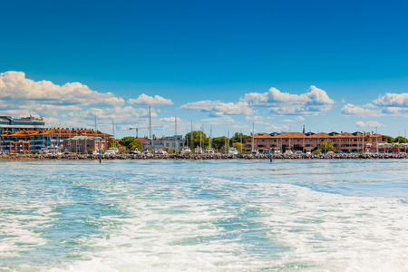 The seaside town of Grado provinces of Gorizia seen from the lagoon on a sunny summer day. Friuli Venezia Giulia, Italy.の写真素材