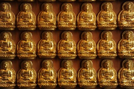 golden buddhist sculpture on wooden wall