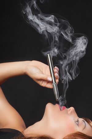 smoking a vape penの写真素材