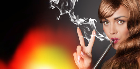 peaceful woman smokes her vape penの写真素材
