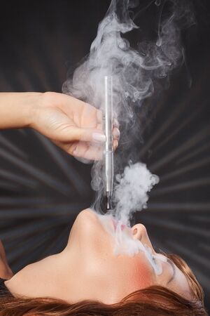 woman smokes her vape penの写真素材