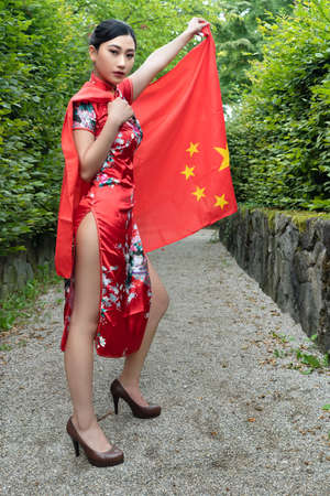 Asian woman posing with the Chinese flagの写真素材