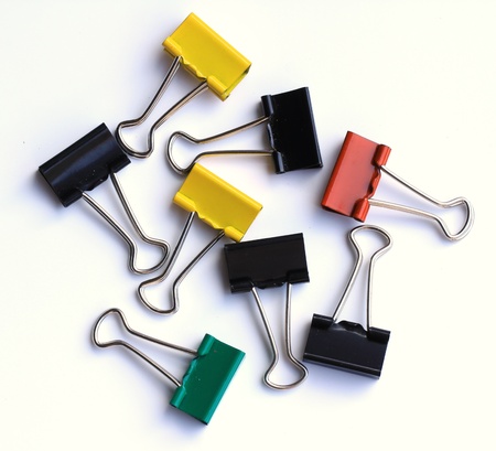 Multi color paper clips on a white background 