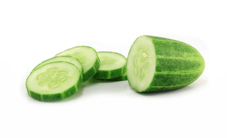 Cucumber and slices isolated over white background  の写真素材