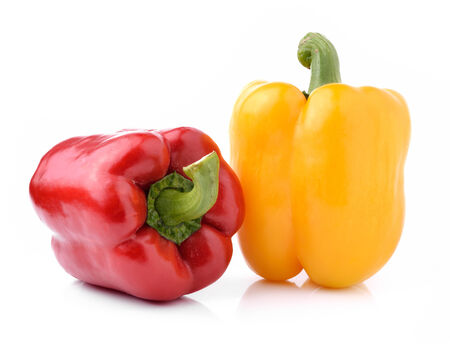 red and yellow pepper bells isolated on white backgroundの写真素材
