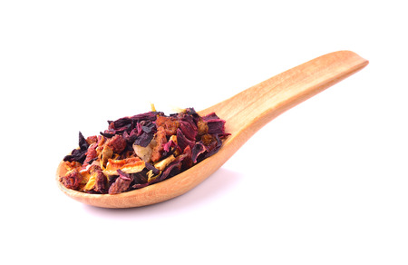 Rose tea in wooden spoon isolated on white backgroundの写真素材