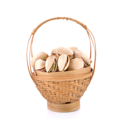 Pistachio nuts in basket on a white background.の写真素材