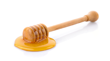 Wooden honey dipper with honeyの写真素材