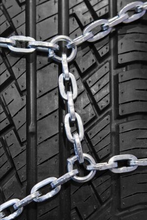 Background of black winter tyre with chainの写真素材