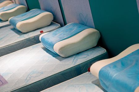 Beds with blue matrass and a white pillowの写真素材