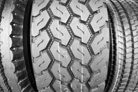 Backgorund of many black rubber tyres with torns