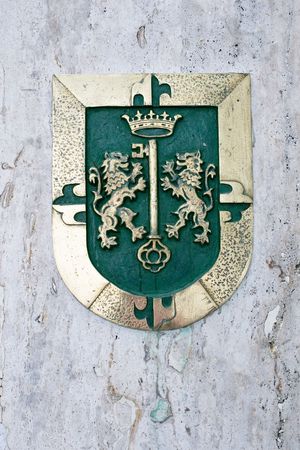 Golden emblem of Santo Domingo on a stone wallの写真素材