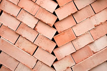 Background of many red bricks for cinstruction in a pallet 