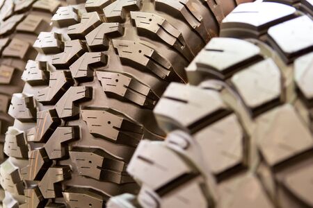 Backgorund of many black rubber tyres with torns