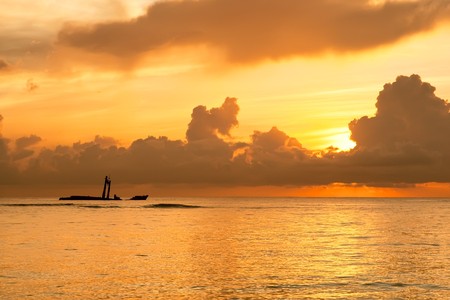 Bright sunrise in early morning with sand beach and ocean in summerの写真素材
