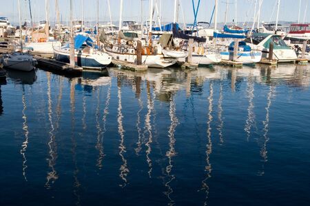 Reflection of sail boats in Marinaの写真素材