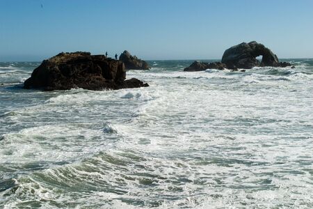 Man Fishing on top of the rockの写真素材