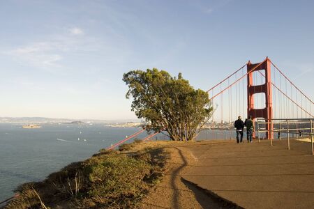 two man walking toward the Golden Gate の写真素材