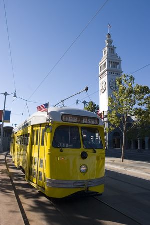 Trolley Yellow with Ferry Building Public transportation in San Francisco Californiaのeditorial素材