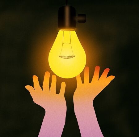 Hands feeling the warmth of the hanging light lamp bulb