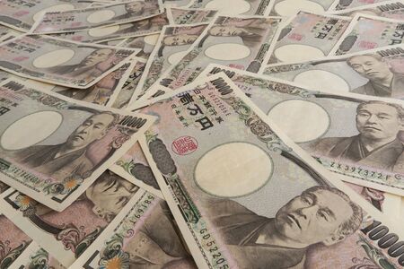 10,000 yen bills in Japanese yen spread out on the front. The bills in the photo are Japanese bills.の写真素材