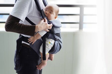 A mother and her five-month-old baby on a walk by baby carrierの素材 [FY310147301211]