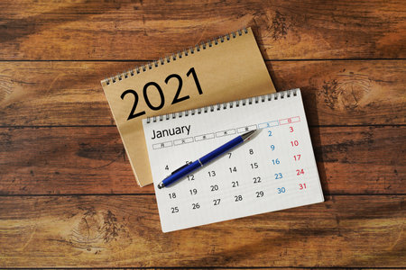 Calendar and smartphone on wooden desk.の写真素材