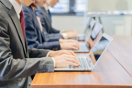 Three male and female businessmen having a meeting on a laptop