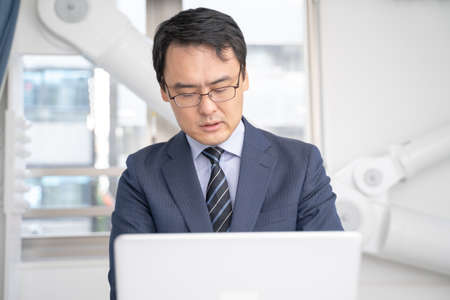 Male businessman working on a laptop in the office