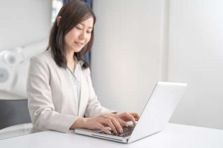 Female businessman working on a laptop in the officeの写真素材