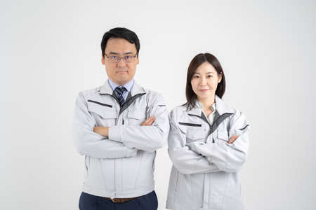 White background of a businessman wearing work clothes for men and women who fold their hands in frontの写真素材