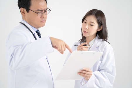 White background image with male and female doctors who have a meeting.の写真素材