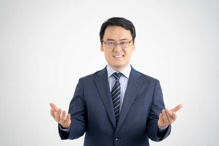 Male businessman who guides the service by hand, white backgroundの写真素材