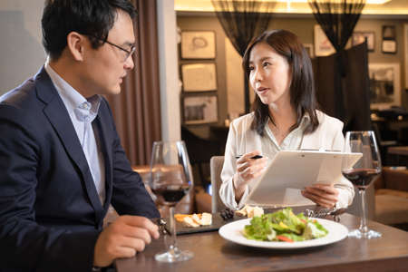 A woman consulting a restaurant menu