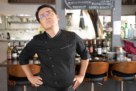 A man who runs a restaurant who is in trouble and depressedの写真素材