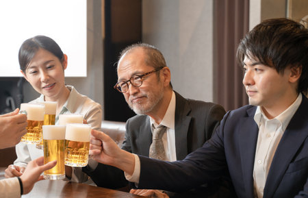 A launch party on the way home from work to toast with beerの写真素材