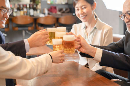 A launch party on the way home from work to toast with beerの写真素材