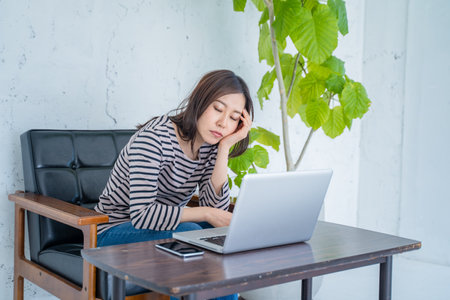 young asian woman working with laptop at home office, business conceptの写真素材