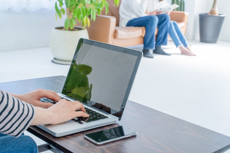 Young woman working with laptop computer at home office. Freelance business concept.の写真素材