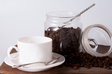Coffee cup and beans on old kitchen table. Top view with copyspace for your textの写真素材