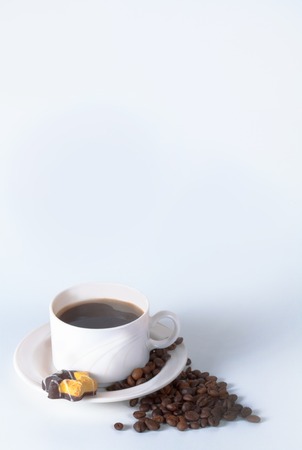 Coffee cup and beans on old kitchen table. Top view with copyspace for your textの写真素材