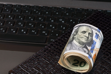 Laptop and notebook,dollars banknote, concept and idea of time value and money, realestate business and finance concepts. retro, green with the handsの写真素材