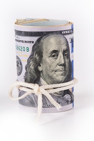 The dollar, a model on a dollar bill, a concept and idea of cost and money in time, real state commercial and financial concepts, symbol of the bank, the storage of money.の写真素材
