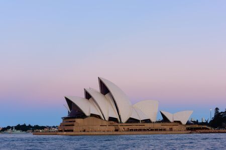 Sydney Opera House on pink and blue sky. 29 AUG 2016  It was designed by Danish architect Jorn Utzon...