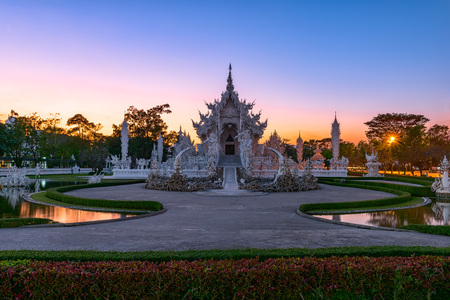 Wat Rong Khun(White temple)at sunset in Chiang Rai,Thailand.23/01/2018 Wat Rong Khun is modern building, well known worldwide.It was designed by Chalermchai Kositpipat.Opened it to visitors in 1997.のeditorial素材