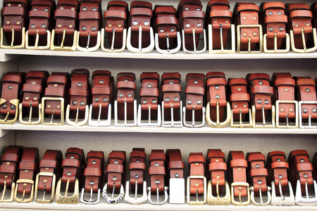 Leather belts exposed on shelfs for saleの写真素材