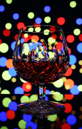 close-up of glass of cognac with colour background