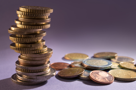 Euro coins stacked on gray backgroundの写真素材