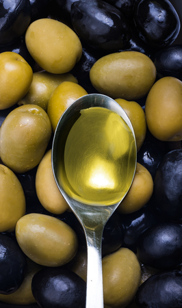 Black and green olives mix with spoonの写真素材