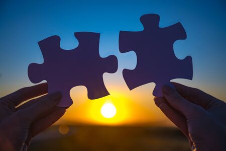 two hands to connect couple puzzleの写真素材